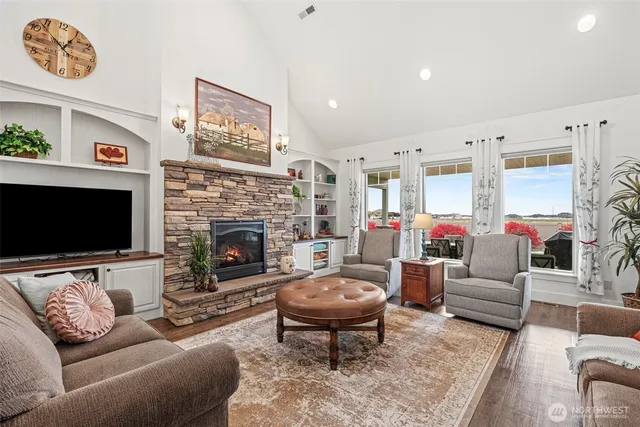 a living room with furniture a flat screen tv and a fireplace
