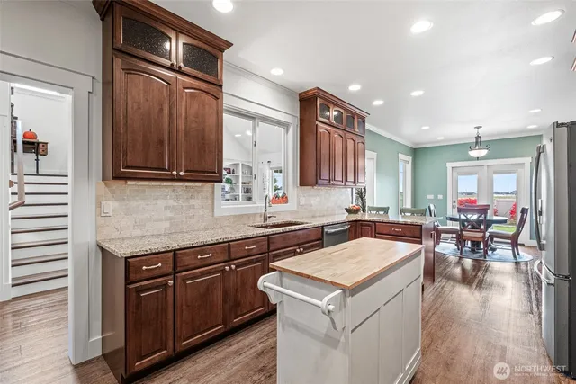 a kitchen with a stove a sink and a refrigerator