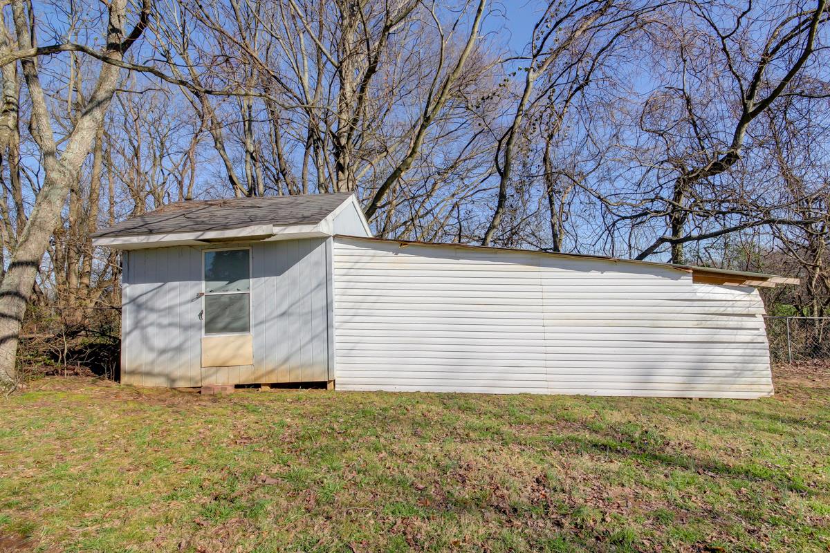 879 Lennox Road Clarksville, TN 37042 - Photo 11 of 30 Large shed enclosed on left and lien to area for other items to the right