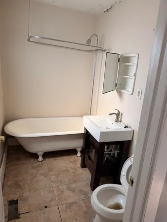 a bathroom with a sink toilet and mirror