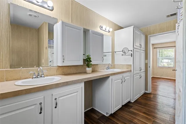 a bathroom with a double vanity sink mirror and