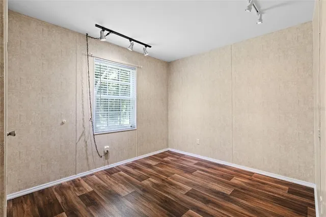 a view of room with window and hardwood floor