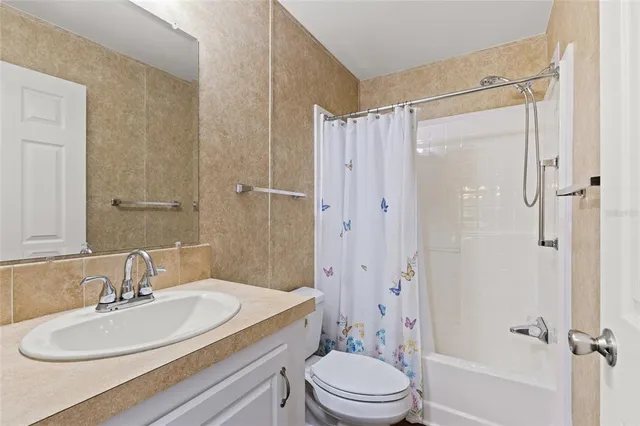 a bathroom with a sink toilet a shower and a mirror