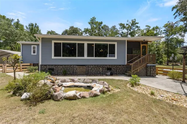 a view of a chair and table in backyard