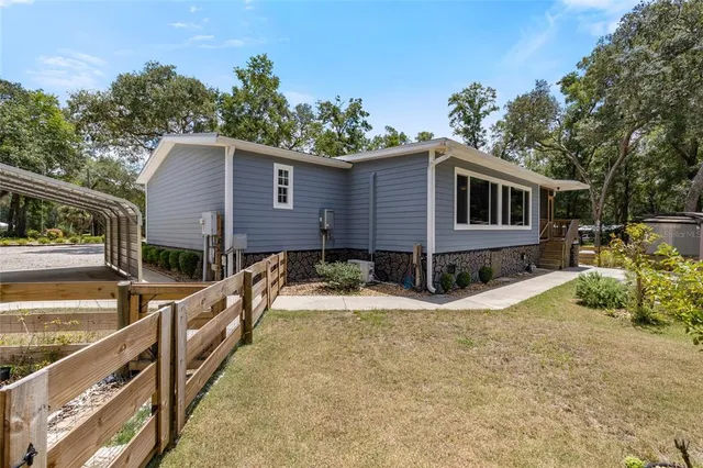a aerial view of a house with swimming pool next to a yard
