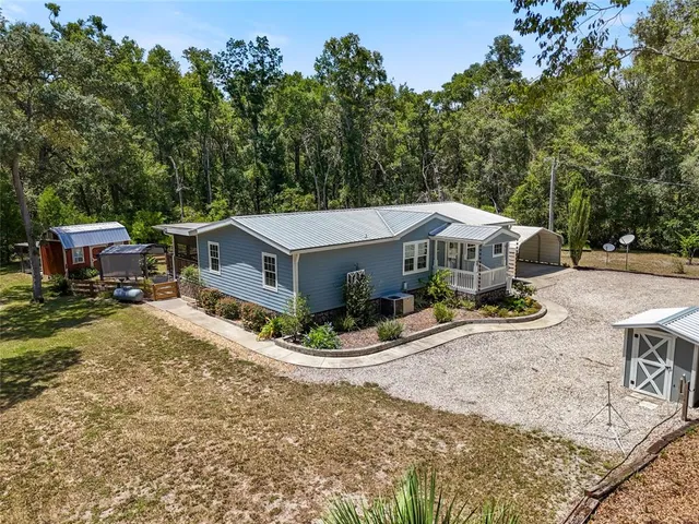 an aerial view of a house with a yard