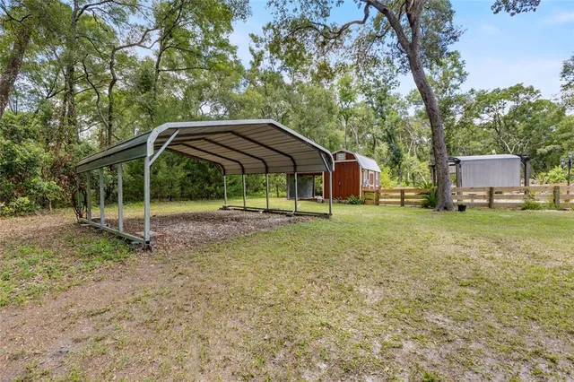 a view of a house with backyard and deck