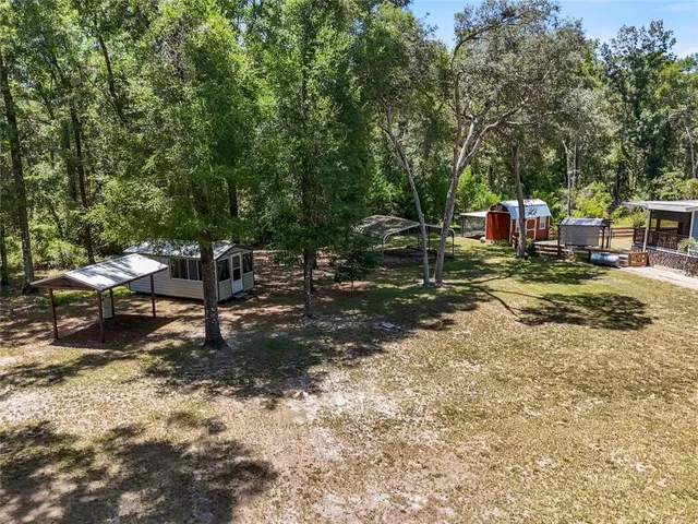 an aerial view of a house with a yard and lake view