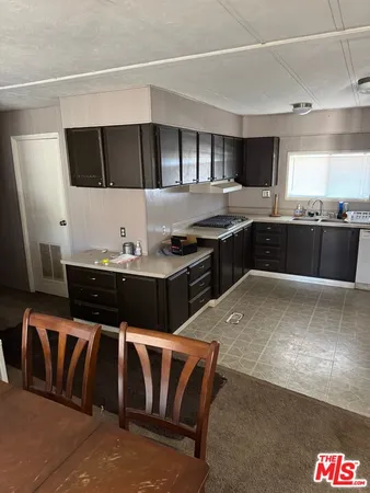 a kitchen with a stove and a refrigerator