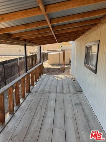 a view of an empty room and wooden floor