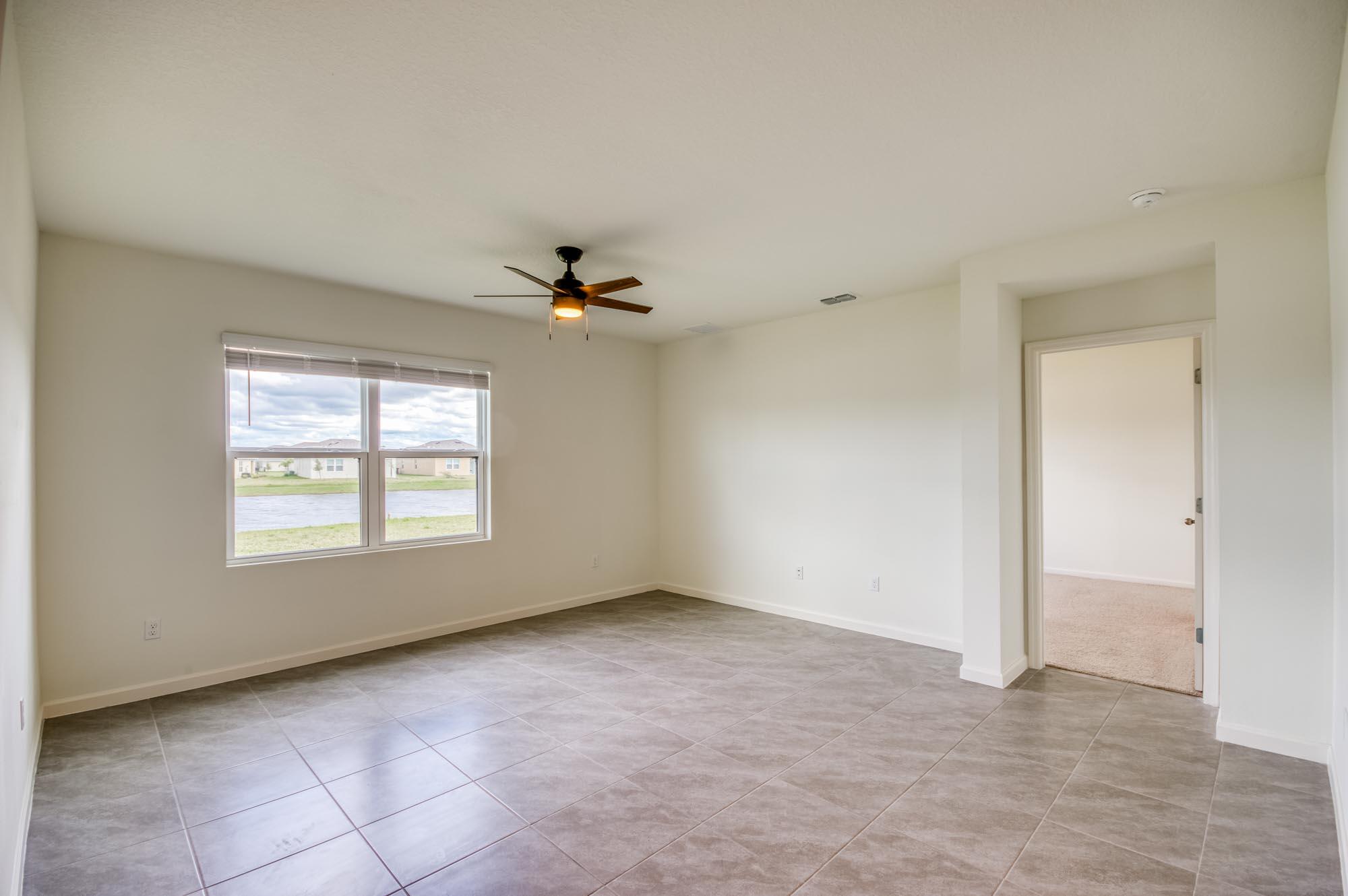 9767 Southwest Triton Way Port Port St. Lucie, FL 34987 - Photo 11 of 52 a view of an empty room with a window