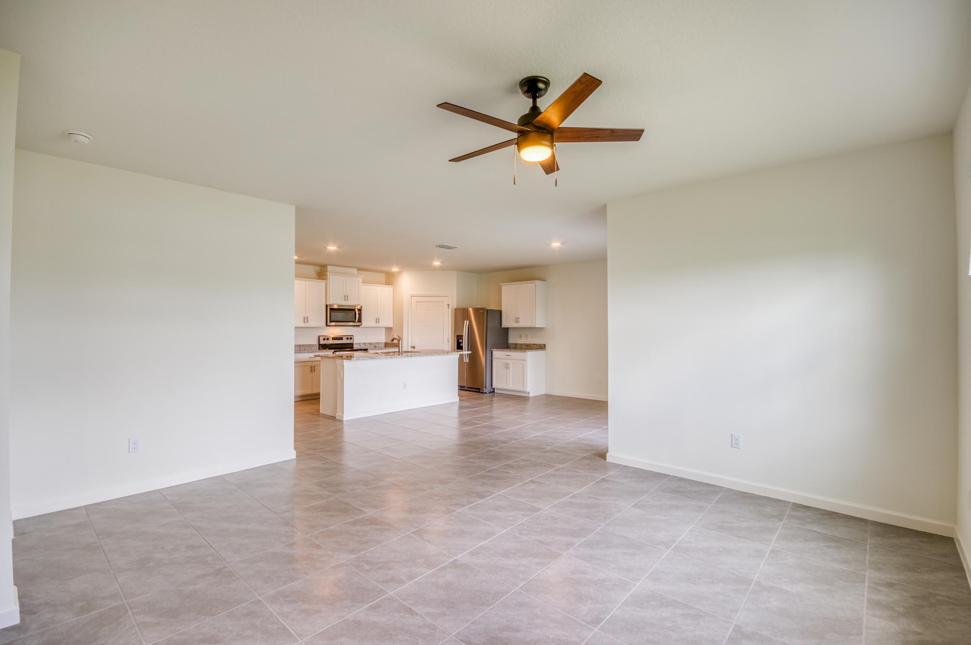 9767 Southwest Triton Way Port Port St. Lucie, FL 34987 - Photo 13 of 52 a view of a kitchen with a sink and a refrigerator