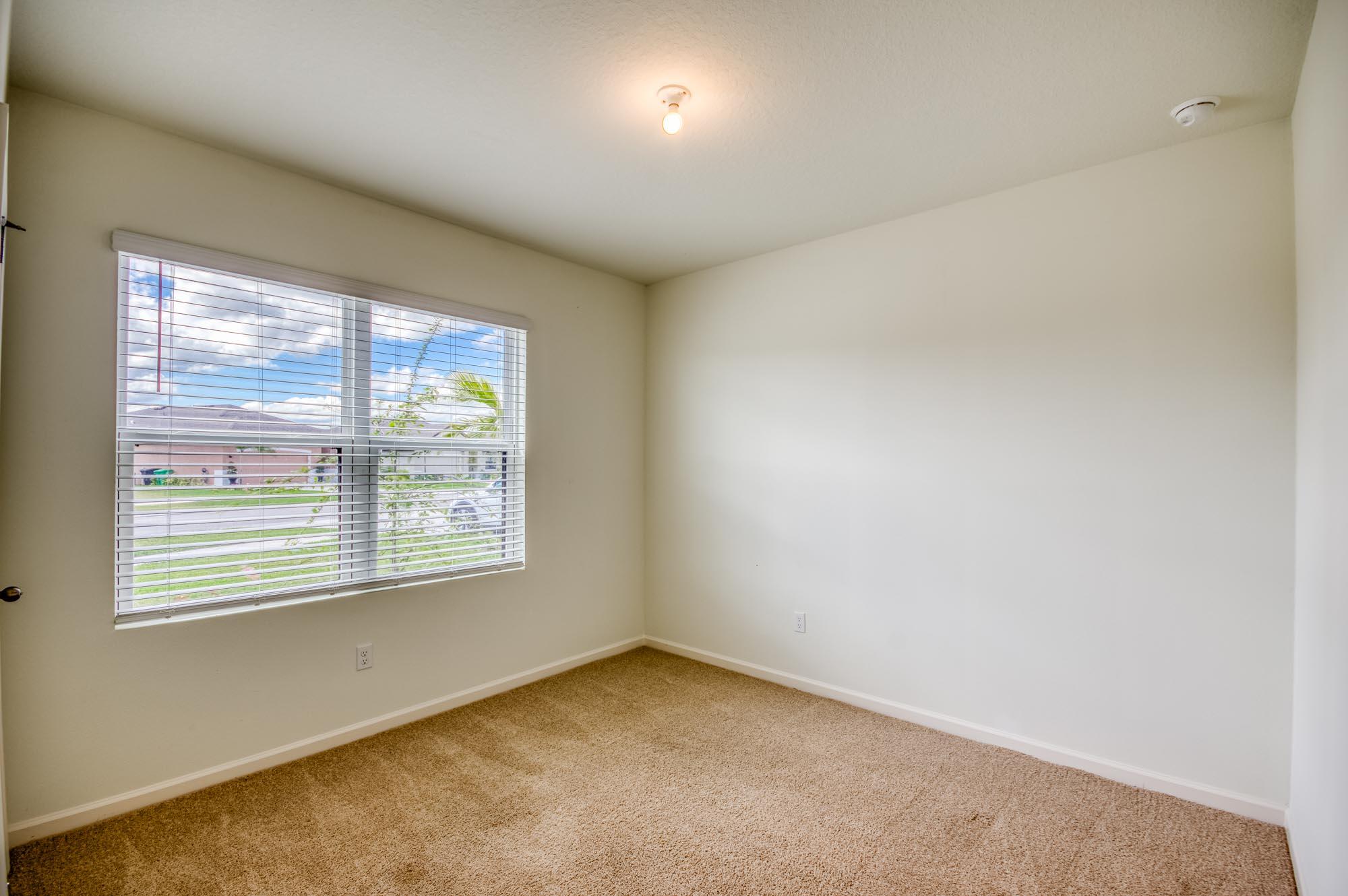 9767 Southwest Triton Way Port Port St. Lucie, FL 34987 - Photo 22 of 52 an empty room with a window