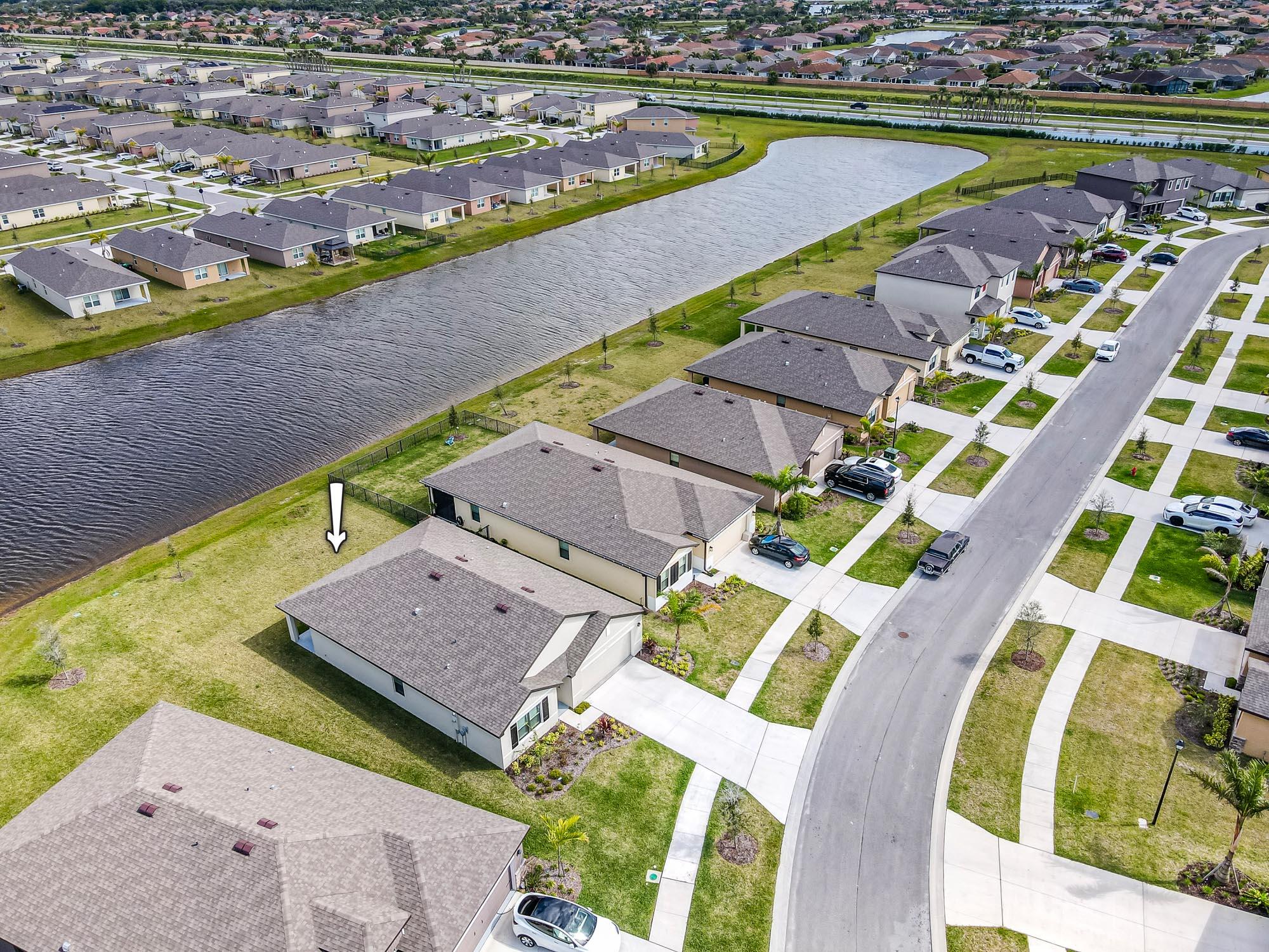 9767 Southwest Triton Way Port Port St. Lucie, FL 34987 - Photo 3 of 52 an aerial view of a house with a swimming pool