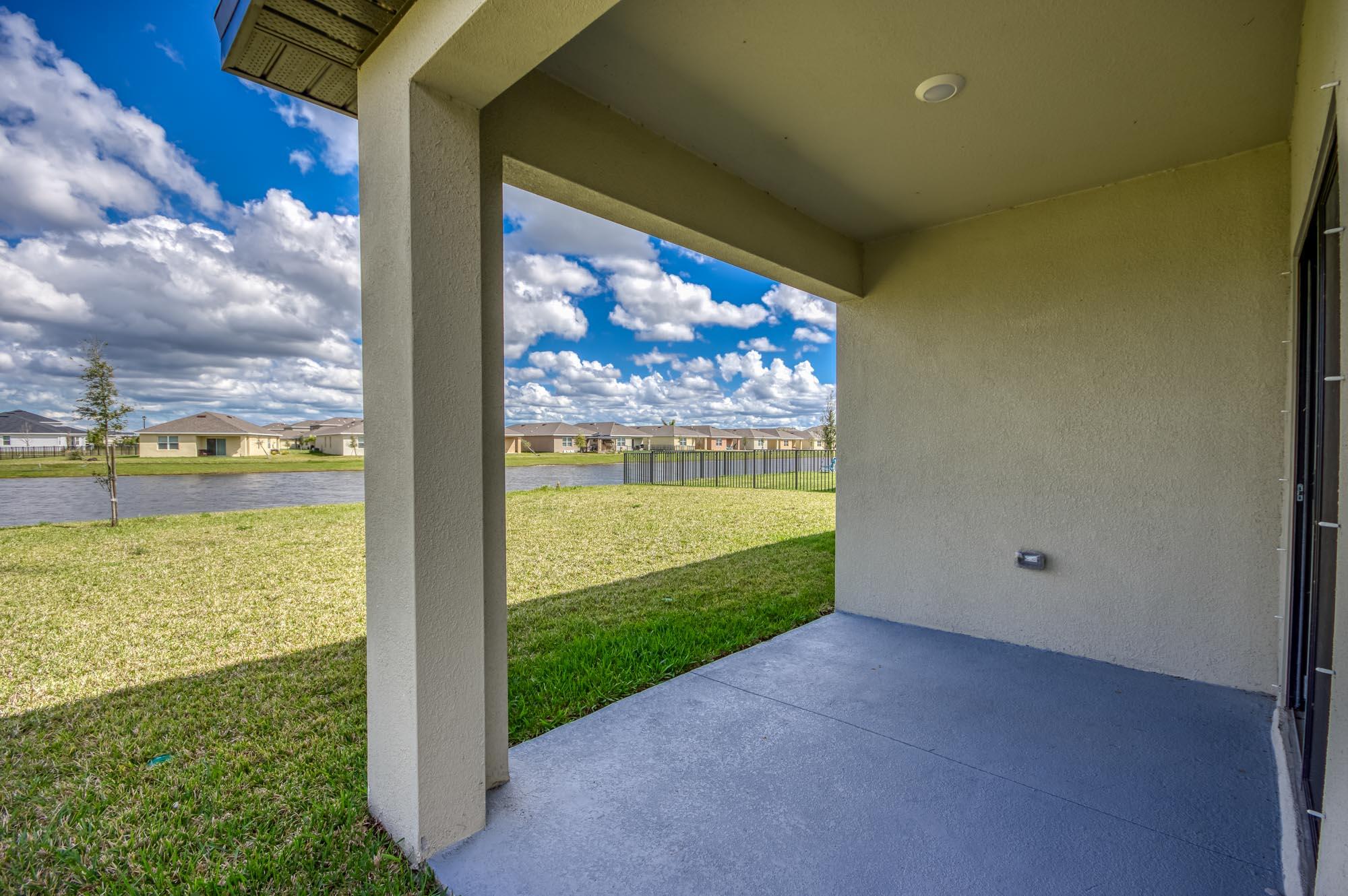 9767 Southwest Triton Way Port Port St. Lucie, FL 34987 - Photo 33 of 52 a view of a room with floor to ceiling windows and yard