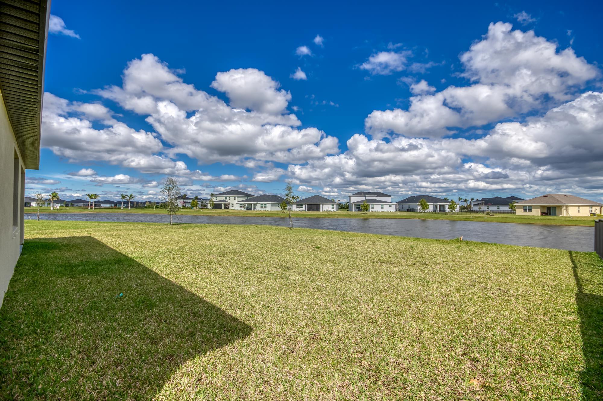 9767 Southwest Triton Way Port Port St. Lucie, FL 34987 - Photo 35 of 52 a view of a large body of water with a building in the background