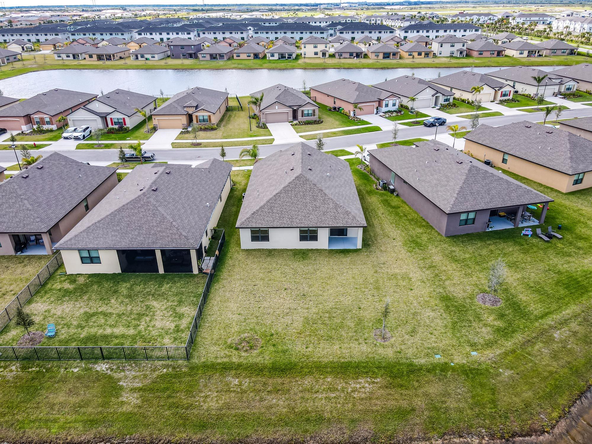 9767 Southwest Triton Way Port Port St. Lucie, FL 34987 - Photo 41 of 52 an aerial view of residential houses with outdoor space and swimming pool