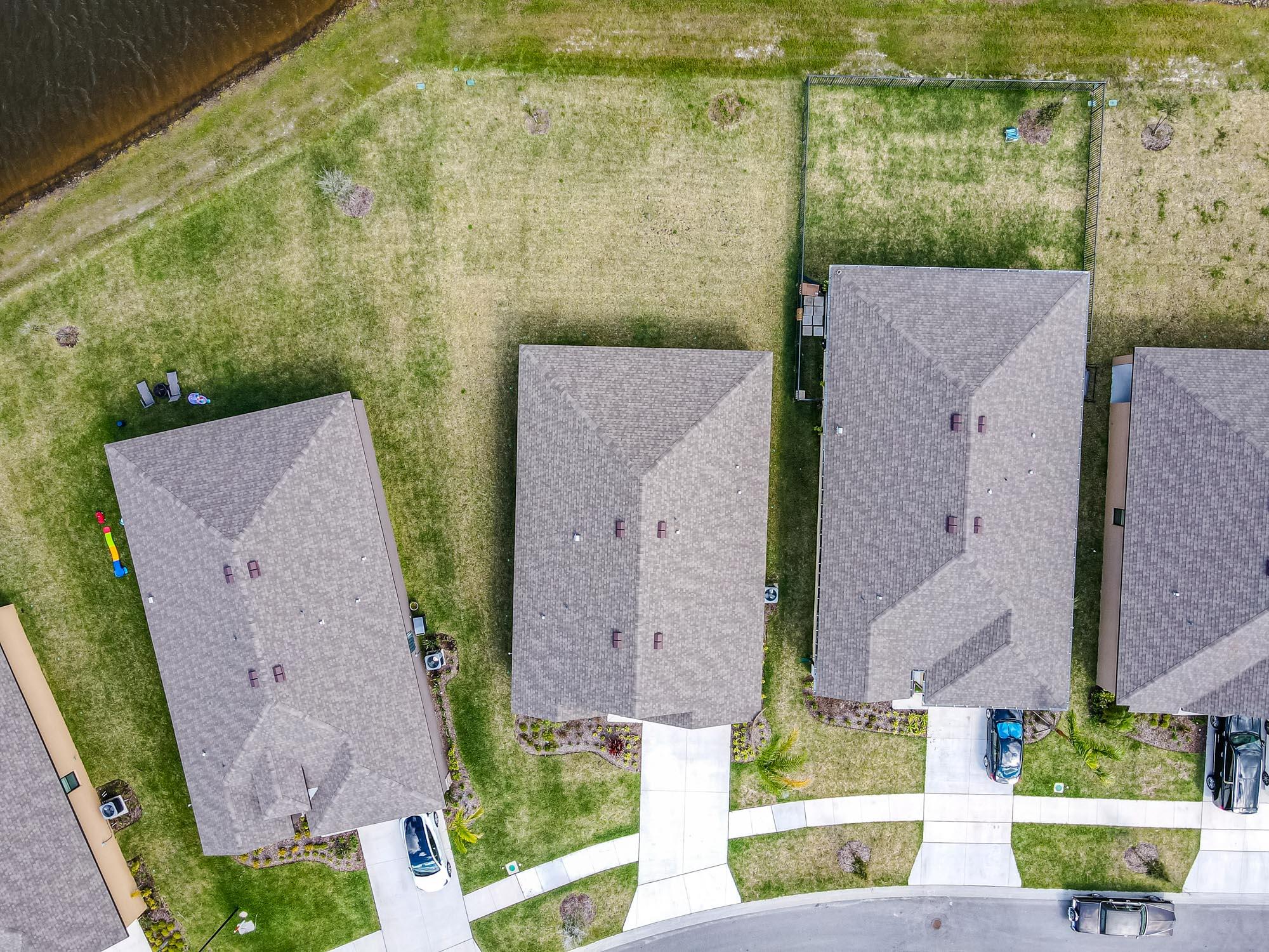 9767 Southwest Triton Way Port Port St. Lucie, FL 34987 - Photo 43 of 52 aerial view of a house with a yard and plants