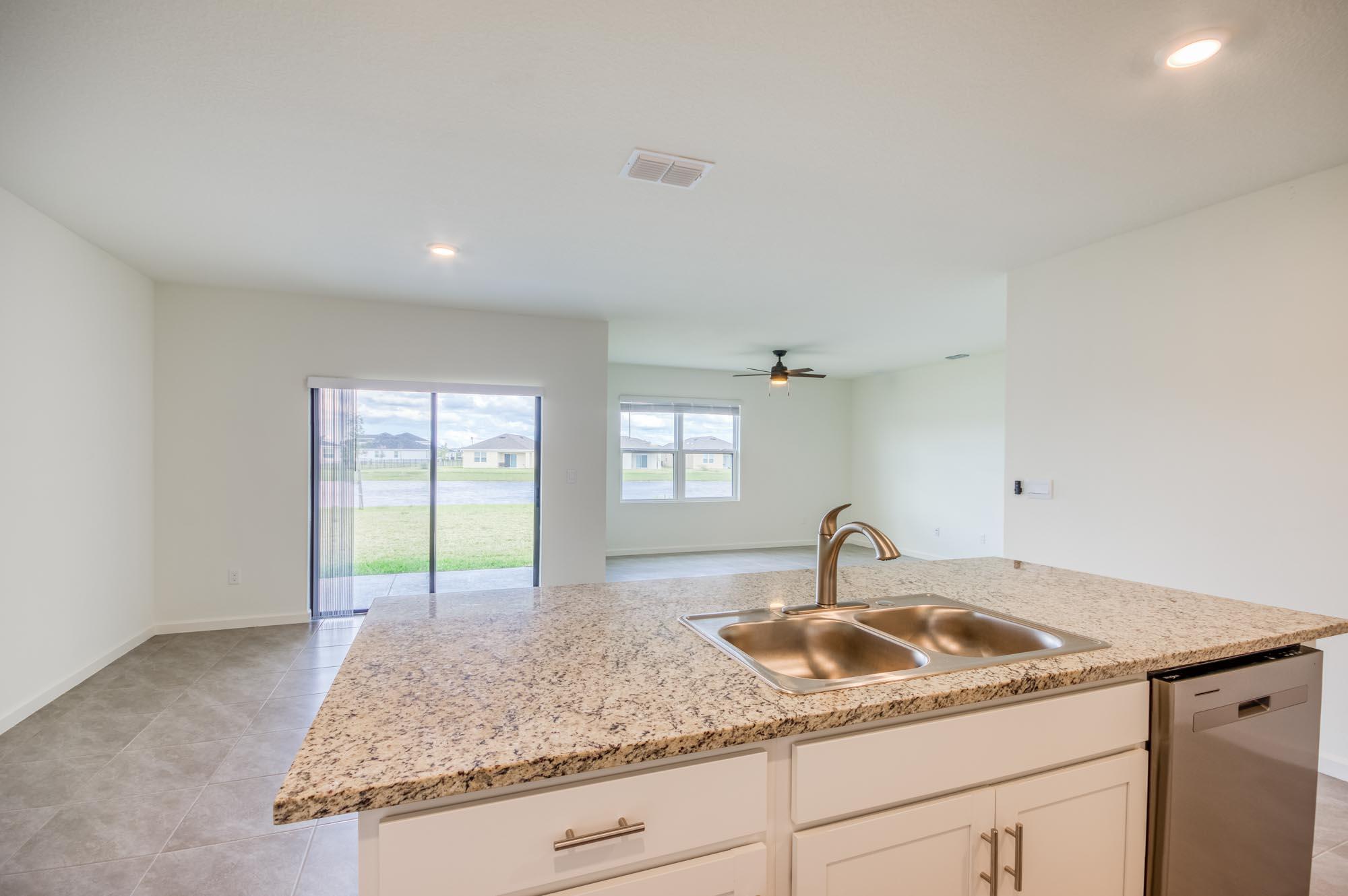 9767 Southwest Triton Way Port Port St. Lucie, FL 34987 - Photo 7 of 52 a kitchen with sink and window