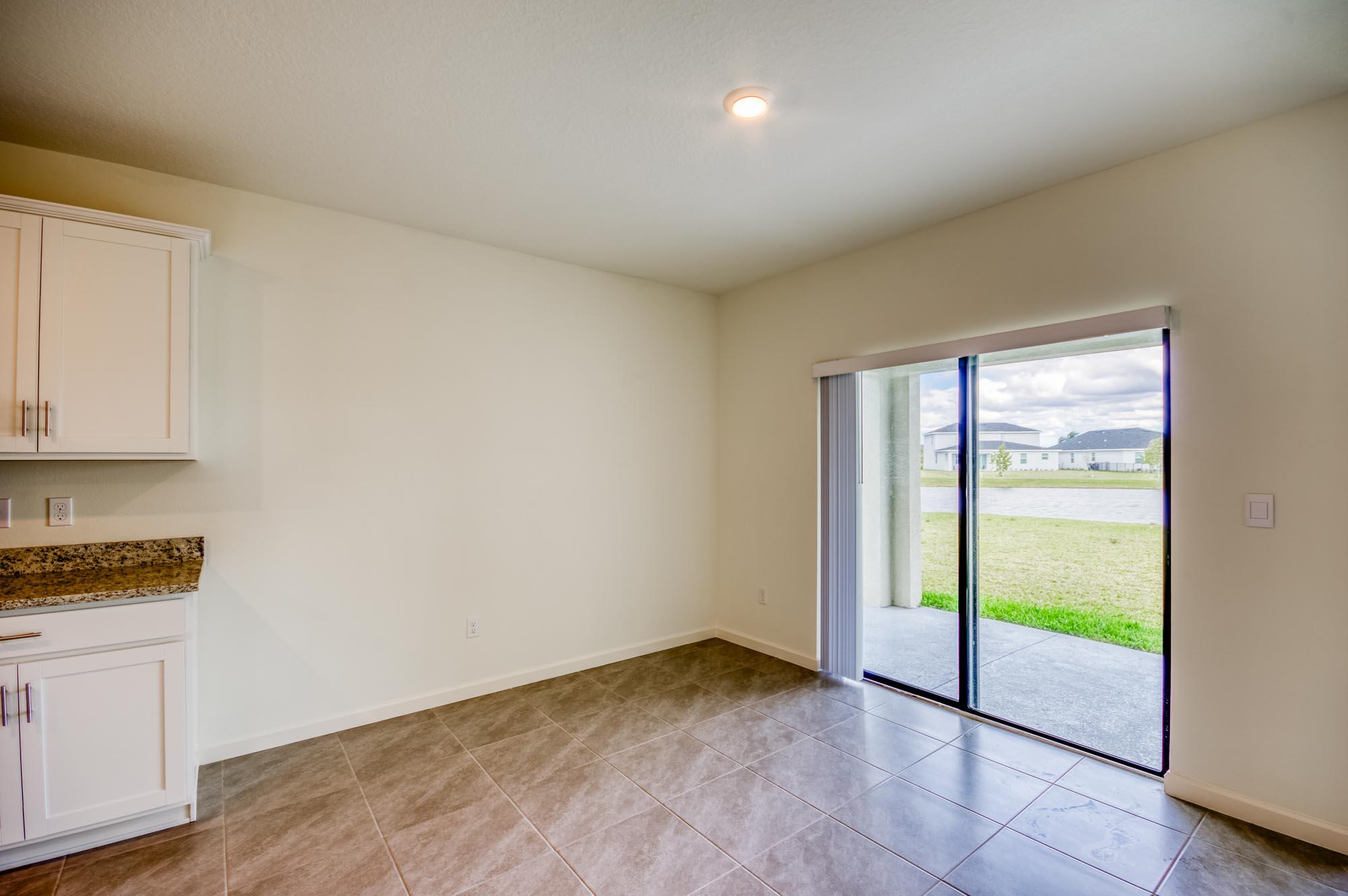 9767 Southwest Triton Way Port Port St. Lucie, FL 34987 - Photo 8 of 52 a view of an empty room with a window