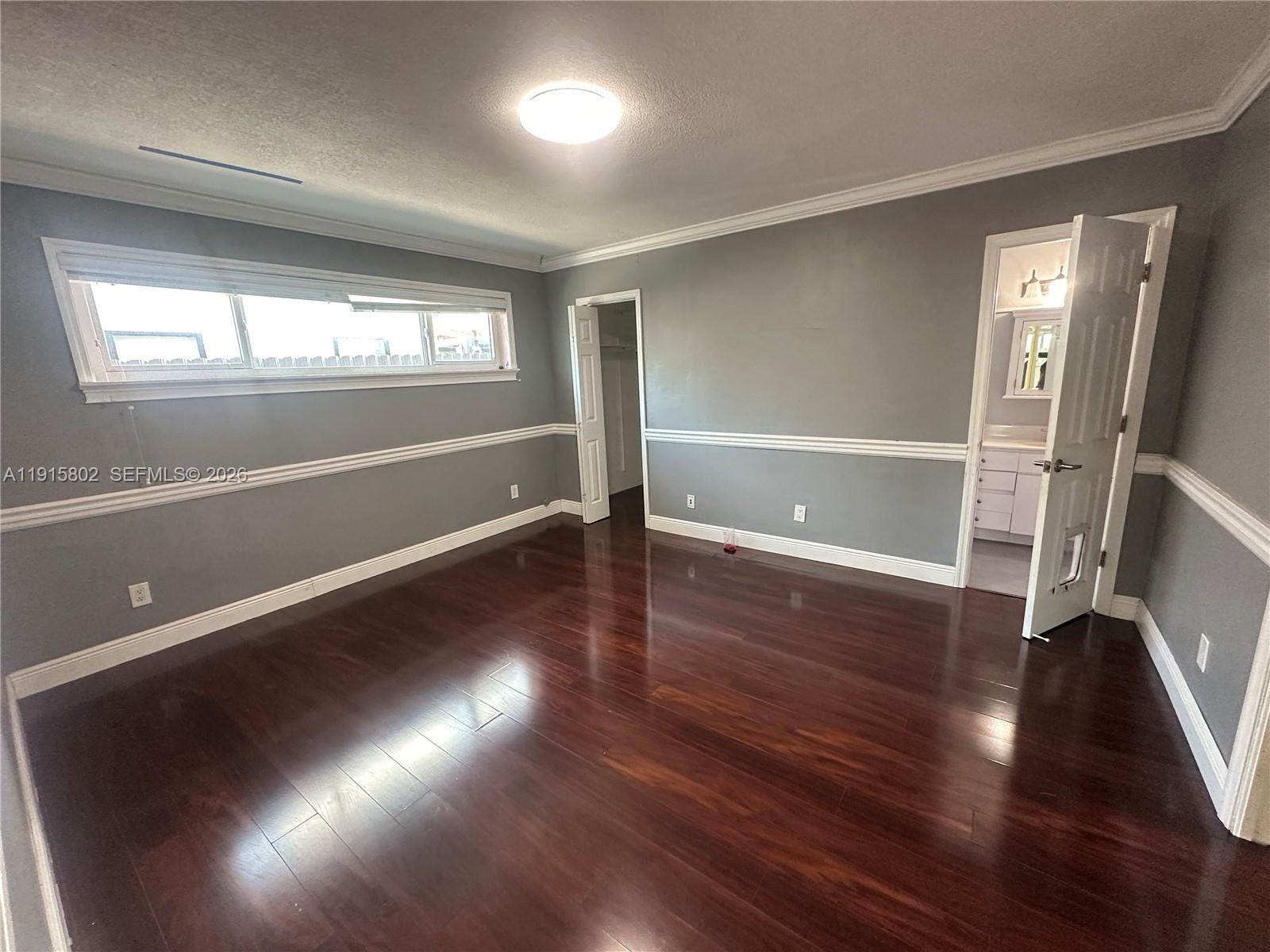 7780 Southwest 28th Street Miami, FL 33155 - Photo 25 of 54 an empty room with wooden floor and windows