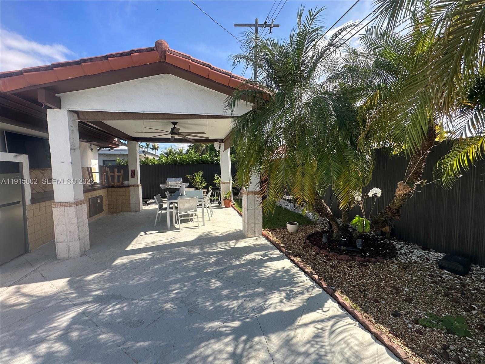 7780 Southwest 28th Street Miami, FL 33155 - Photo 10 of 54 a patio with table and chairs and potted plants