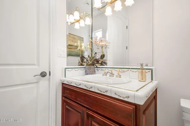a dining room with wooden floor a chandelier