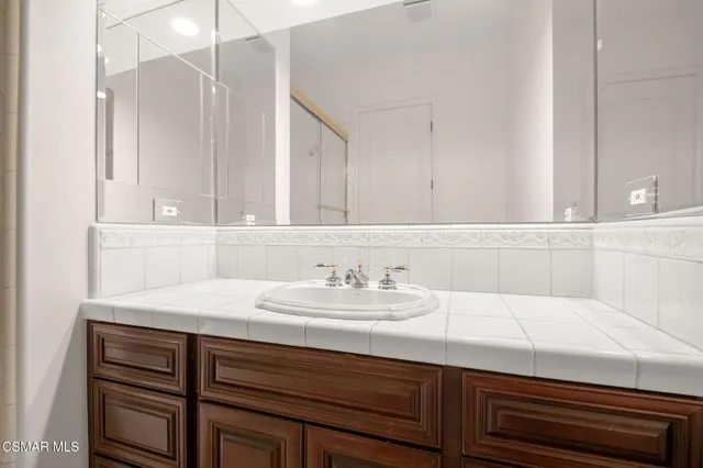 a kitchen with stainless steel appliances granite countertop a sink a stove a dining table and chairs