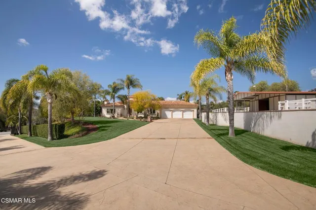 a view of multiple houses with a yard and potted plants