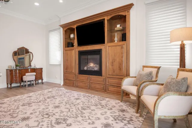 a view of a house with pool and sitting area