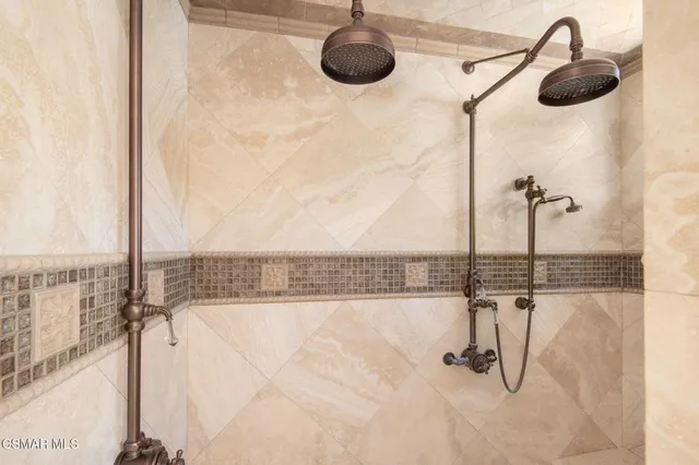 a view of a house with a small yard and large trees