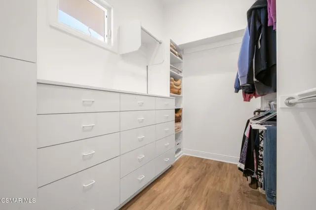 an aerial view of a house with swimming pool and mountains