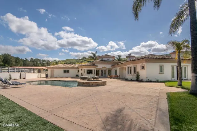 an aerial view of a house with yard swimming pool and outdoor seating
