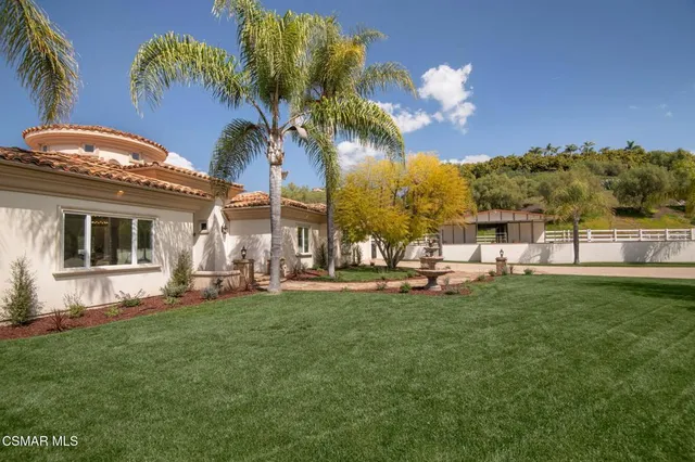 a view of a house with a yard porch and sitting area