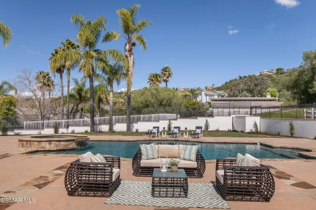 a view of a house with swimming pool patio and a garden