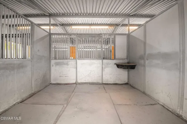 a front view of a house with garden and trees