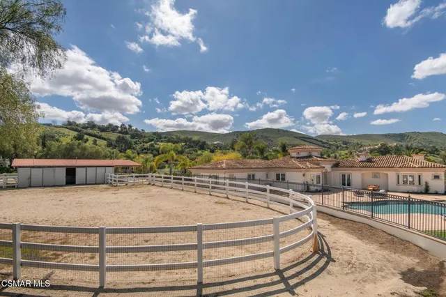 a view of swimming pool with a table and chairs