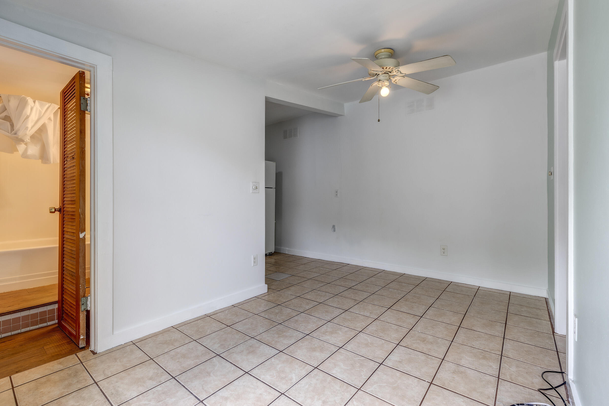 1318 Duncan Street, Unit 3 Key West, FL 33040 - Photo 6 of 10 an empty room with windows and ceiling fan