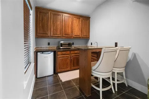 a view of a kitchen with chair and window