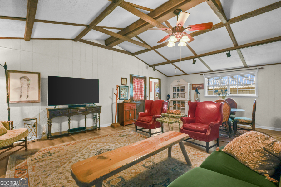 780 David Carter Road Baxley, GA 31513 - Photo 11 of 35 a living room with furniture a flat screen tv and a table