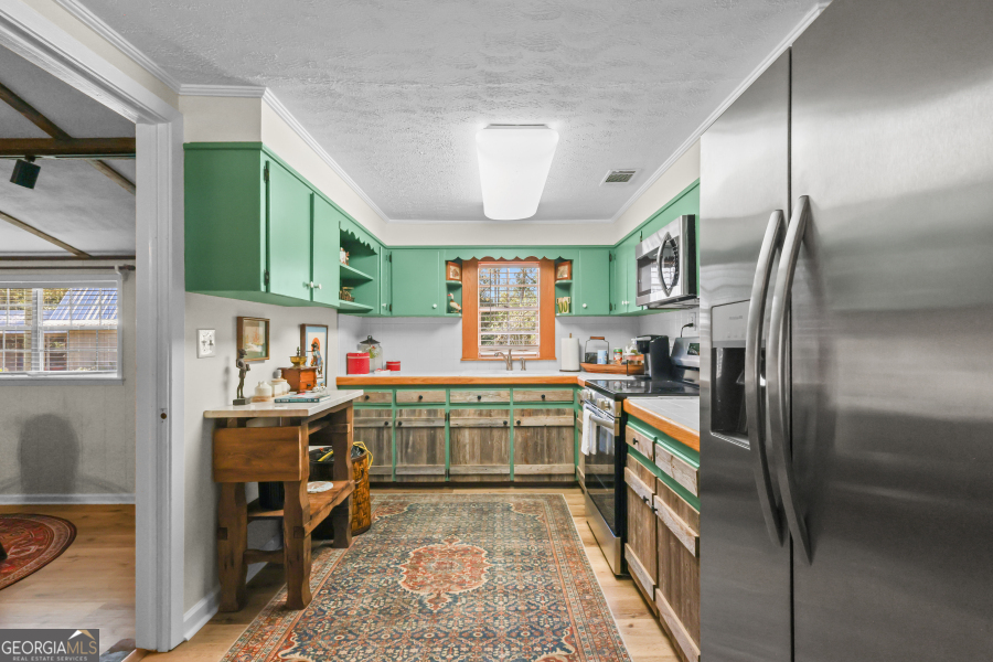 780 David Carter Road Baxley, GA 31513 - Photo 13 of 35 a kitchen with kitchen island a sink stove and refrigerator