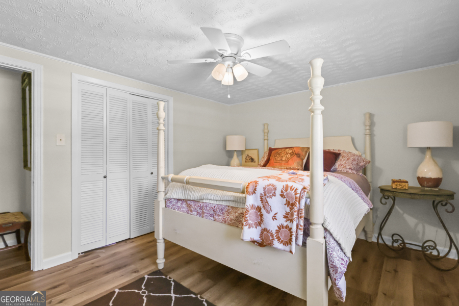 780 David Carter Road Baxley, GA 31513 - Photo 19 of 35 a bedroom with a bed and wooden floor