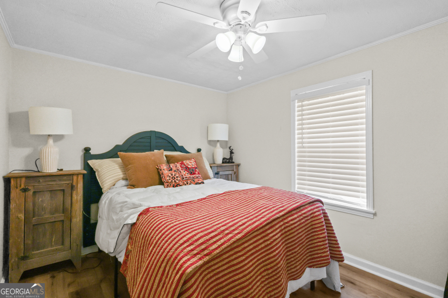 780 David Carter Road Baxley, GA 31513 - Photo 20 of 35 a bedroom with a bed and a chandelier