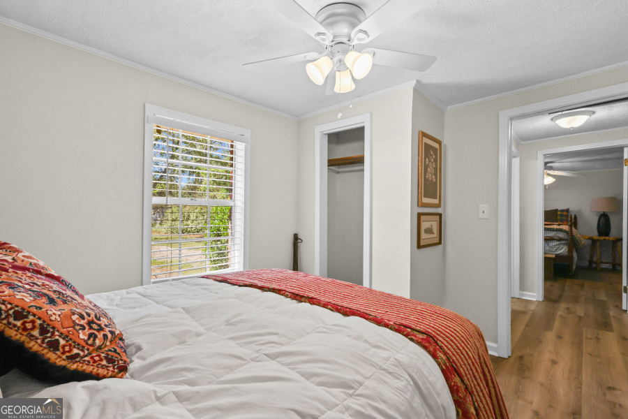 780 David Carter Road Baxley, GA 31513 - Photo 21 of 35 a bedroom with a large bed and a chandelier