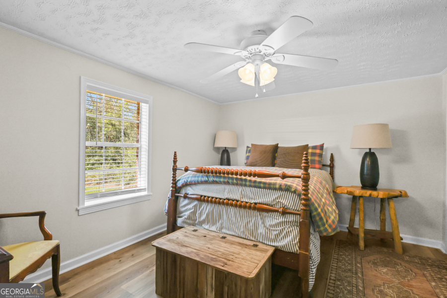 780 David Carter Road Baxley, GA 31513 - Photo 22 of 35 a bed sitting in a bedroom next to a window