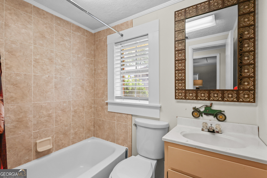 780 David Carter Road Baxley, GA 31513 - Photo 25 of 35 a bathroom with a sink toilet a mirror and shower