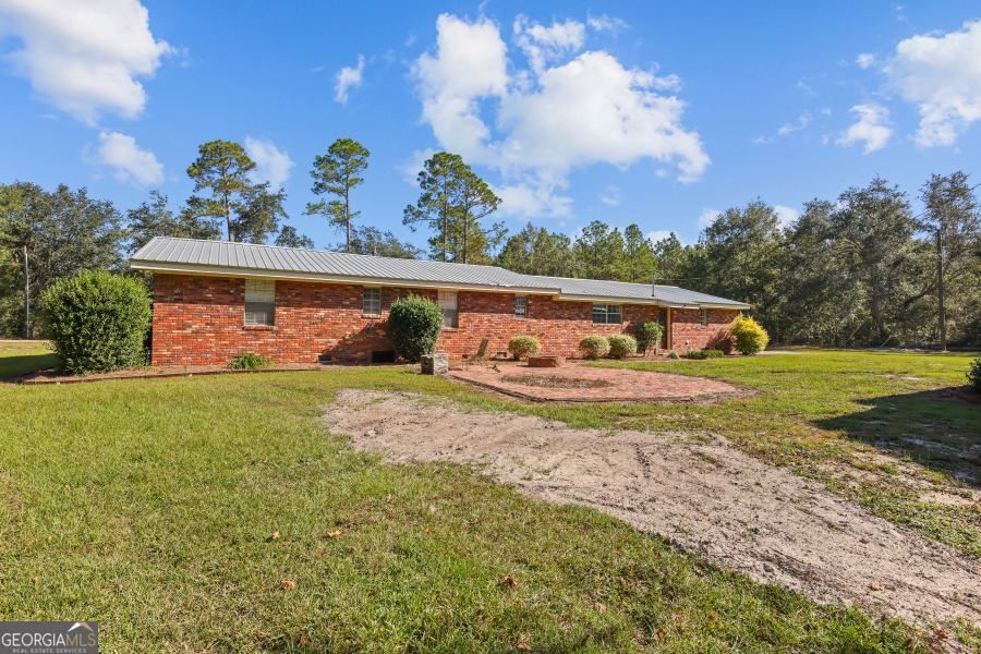 780 David Carter Road Baxley, GA 31513 - Photo 28 of 35 a view of a house with a yard