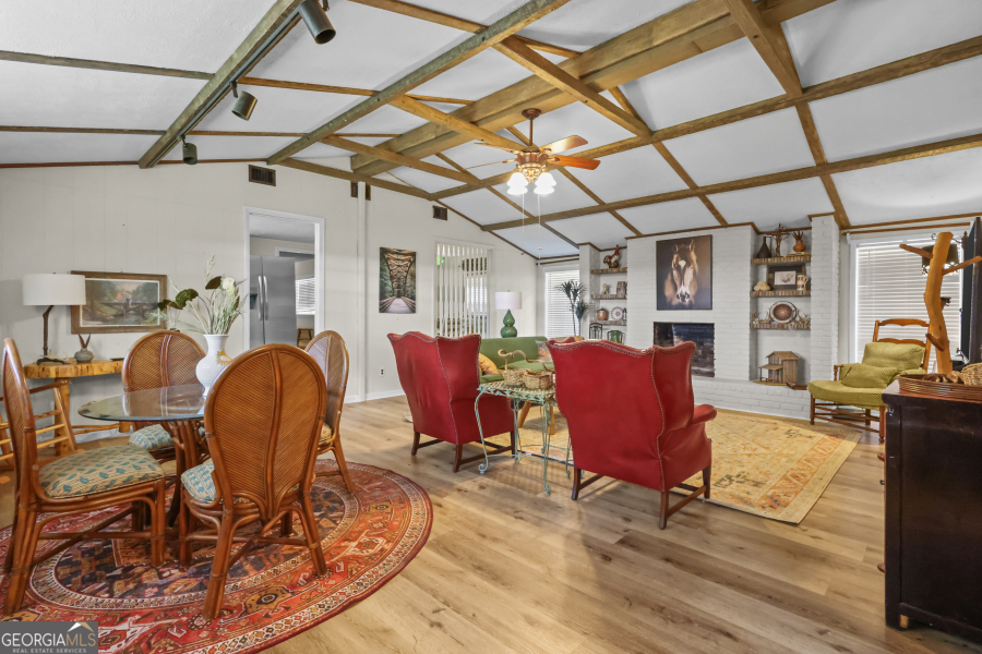 780 David Carter Road Baxley, GA 31513 - Photo 7 of 35 a view of a dining room with furniture a chandelier and wooden floor