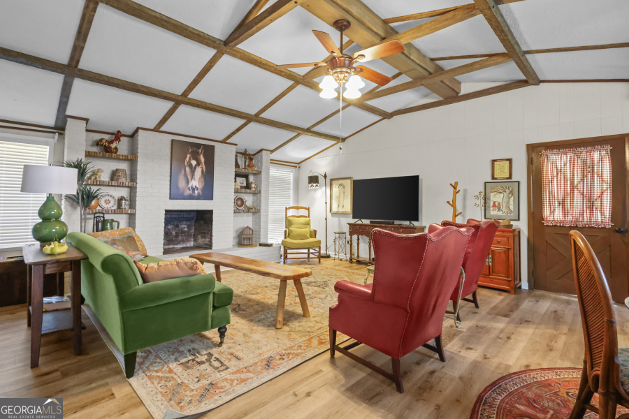 780 David Carter Road Baxley, GA 31513 - Photo 8 of 35 a living room with furniture a flat screen tv and a fireplace