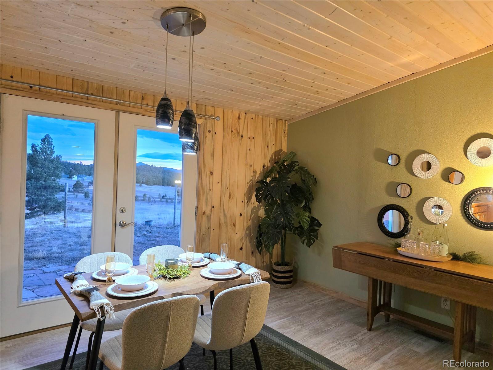 891 South Mountain Estates Road Florissant, CO 80816 - Photo 11 of 43 a dining room with furniture and a table